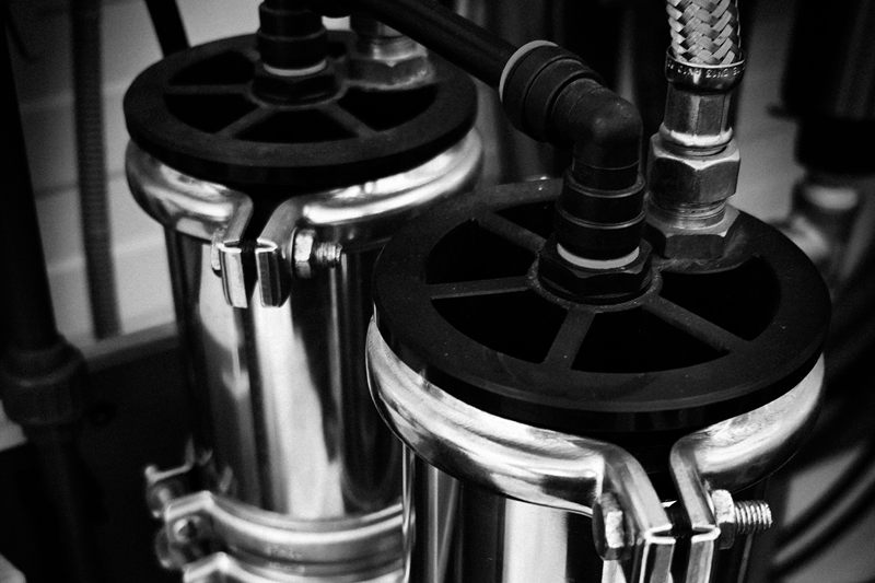 Stainless steel whole-house water filter housings with plumbing connections
